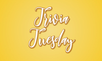 A banner with a yelloe background and white script which reads Trivia Tuesday