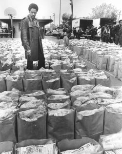 jthommy13:  Black Panther Party leader Bobby Seale looking over bags of food to be donated to the local Black community. 