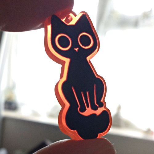 starpatches:Black cat charms on fluorescent orange acrylic!http://starpatches.tictail.com/product/bl