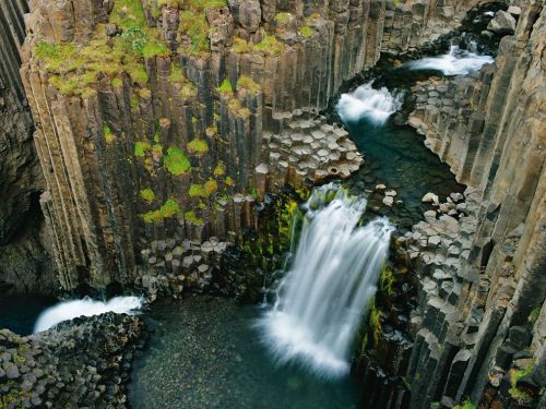 fuckyeahvolcanoes:“At Litlanesfoss, the waterfall cross-sections an ancient lava flow, which f