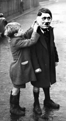 A young boy adjusts his friend’s Adolf