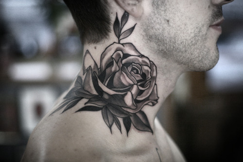 Super cool graphic black and grey rose on the neck by @seanwrighttattoos