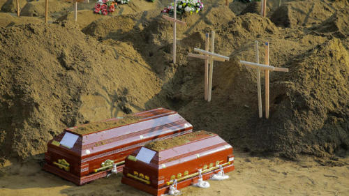 Coffins of Easter Sunday attacks victims lay at a mass burial ground in Katuwapitiya village in Nego