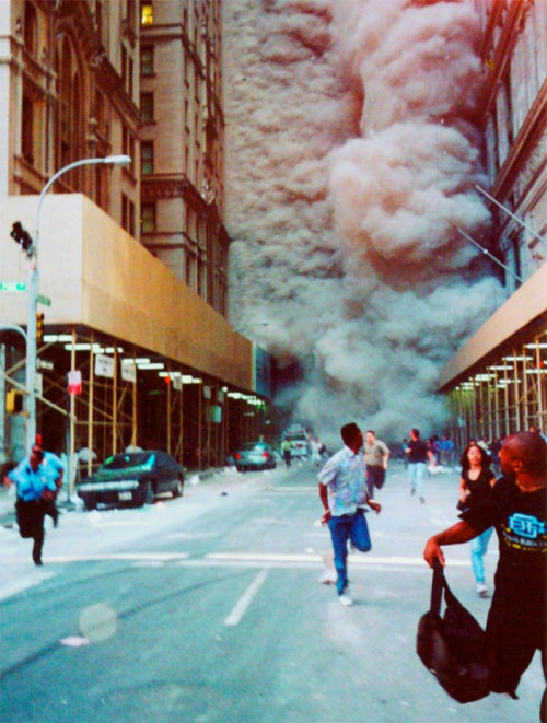 through-a-historic-lens:  People Run Down Broadway As A Smoke And Dust Cloud Comes Up The Street From The Collapsing World Trade Center Buildings In New York  11th September 2001  