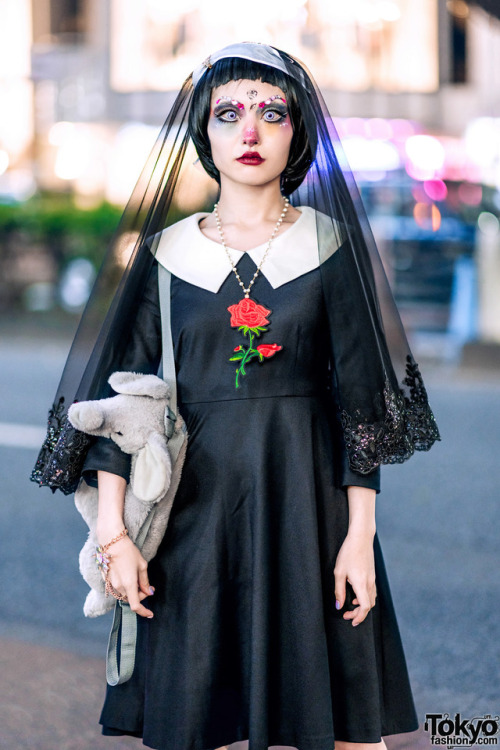 Japanese creator Millna on the street in Harajuku wearing a gothic look featuring doll makeup, a lac