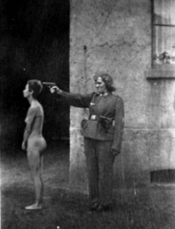 livalskare:  what-a-wonderful-war:  Jewish woman executing by SS guard woman in the concentration camp.  “Humans&quot;…