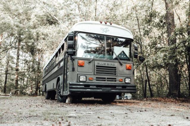 Marine veteran Jessica Rambo converted an old school bus into a traveling art studio for veteran artists. She did all the work herself, including a little succulent rock garden on the dashboard.After completely gutting it, she turned it into a rustic tiny home. (You can see where she DIY’d it and the walls and ceilings don’t quite meet, but she did a great job.)It was a major undertaking for her.The bus took 2 yrs. to complete and it’s now a home and a mission for Jessica, her 2 kids, 2 dogs, and a cat. Some friends helped with the plumbing, etc., on the 1997 Bluebird bus.Jessica wanted to emphasize the wood paneling to give it a rustic cabin feel. The bathroom has a full metal trough soaking tub and private composting toilet area.The children sleep on full size bunk beds. In the kitchen, the oven is set up beneath the butcher block counter, to add more work space. Painting the cabinets teal gives it a homey touch. The tiny Zen garden is meant to welcome guests. She named the bus/studio “The Painted Buffalo,” and she brings art to her fellow marines. https://inhabitat.com/marine-veteran-converts-a-school-bus-into-a-nonprofit-traveling-art-studio/painted-buffaloimg_0182-2/ #converted school bus #skoolie #traveling art studio  #rustic style skoolie #long post