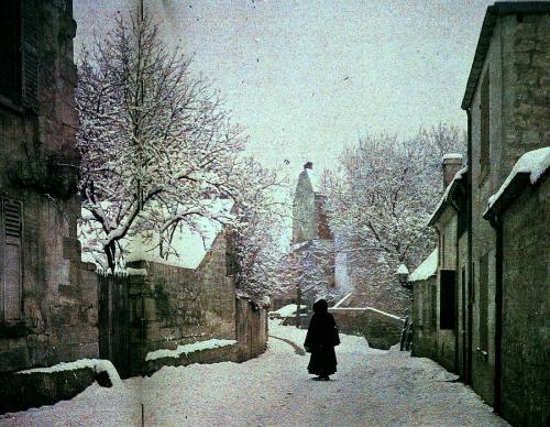 historicaltimes:An unknown woman walks through a French village, Autochrome, c.1910 via reddit