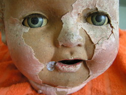 hazedolly:  Peeling composition doll head with tin litho eyes. Photo source: eBay.com 