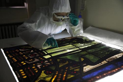 Glass specialist Claudine Loisel checks the Notre Dame cathedral&rsquo;s stained-glass windows a