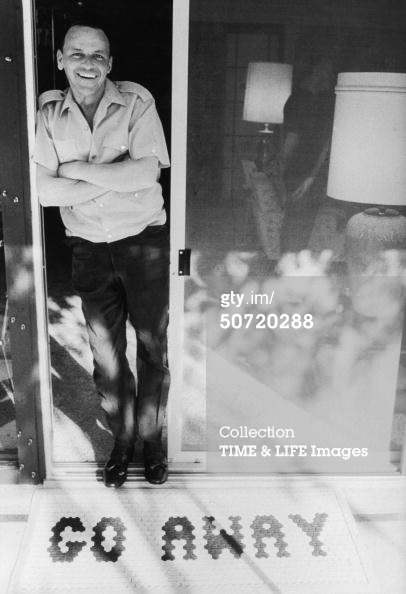 foreverfranksinatra:  Frank photographed at his home, with his ‘Go Away’ mat.