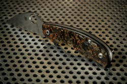 cuscadi:  it looks like magic. Spyderco Urban with custom made copper infused shred carbon scales.