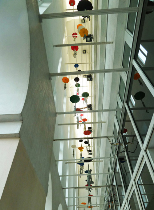 architizer:   Hang In There! Figures Dangle From Umbrellas Inside This Prague Office 
