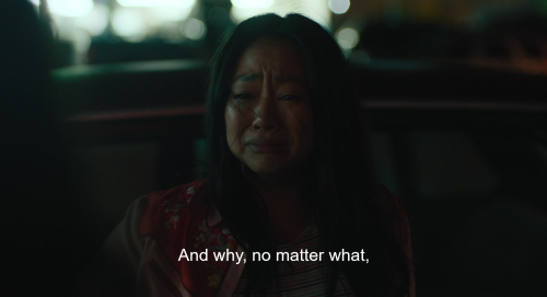 A screencap from the film Everything Everywhere All At Once. A young woman, Joy, wears an expression of deep misery as she listens to her mother, Evelyn, who is not shown in this screencap, speak. The caption reads: 'And why, no matter what,'