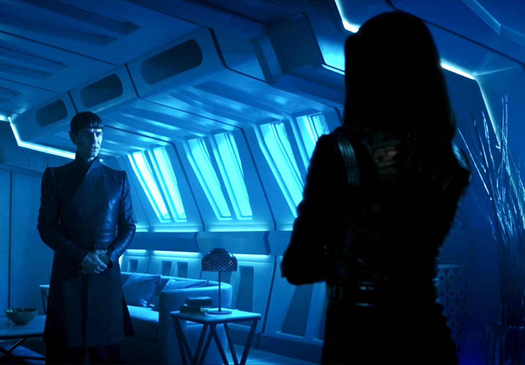 Image ID: a screenshot of Sarek and Mirror Philippa Georgiou from star trek: discovery. They are in a dark room facing each other. End ID
