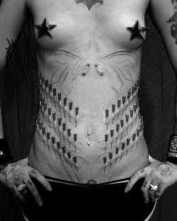 howsaucy:  Play piercing by Max Brand (All or Nothing Tattoo, Atlanta, Ga.), model *Stitch*, 56 needles. Via BMEzine/Modblog.play piercingn