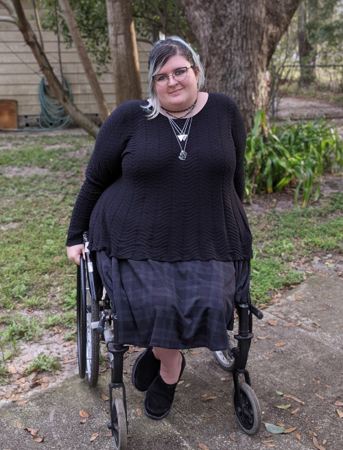 Me? Outside??[ID: two photos of me dressed in a black shirt and skirt sitting in my wheelchair. I am