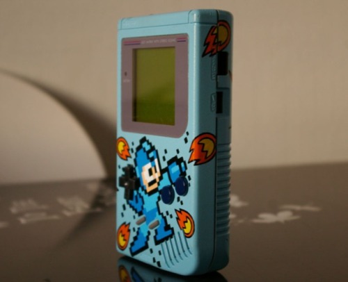 pxlbyte:  Custom Mega Man Game Boy This was created by Oskunk and unfortunately this is a one of a kind design, he has no plans on creating another. It should also be noted that he used the standard gray model as a base, so its truly a 100% custom design.