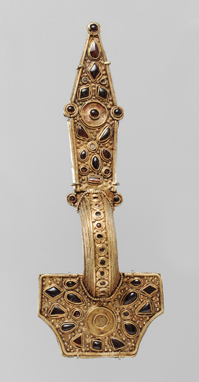 Brooch, first half of 5th centuryEastern GermanicSilver with gold sheet overlay, garnetsThis brooch 