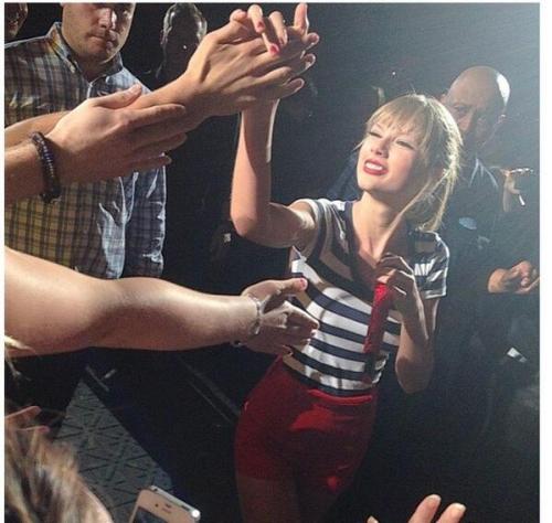 redtournews:Taylor holding a fans hand tonight as she walks through the crowd!