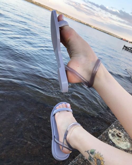 Banded jelly sandals by the water.