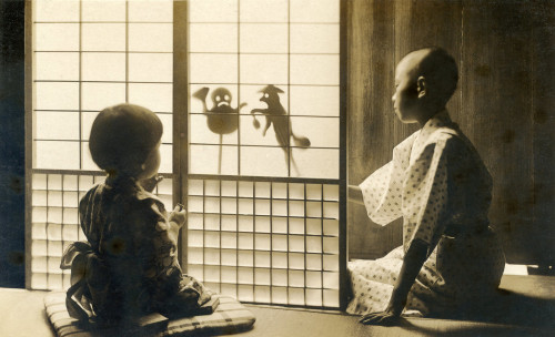 thekimonogallery: Japanese Shadow Puppets 1910s. A boy using a shoji (paper sliding door) to perform