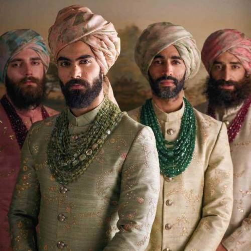 Mens wear by Sabyasachi Mukherjee.The men wear pale hand-embroidered raw silk sherwanis and hand-pri