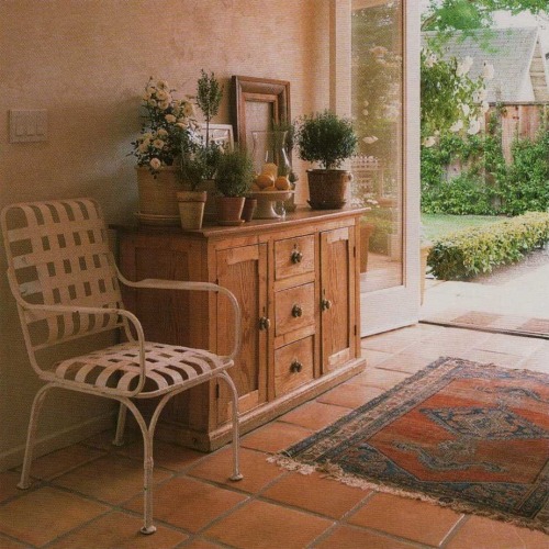 Terra-cotta pavers were a practical choice for the front entry. The pine chest is an old garage-sale