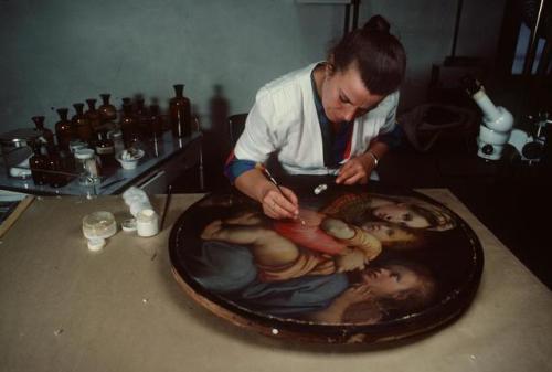 dolm:Italy. Florence. 1984. A restorer works on a Raphael painting at the Forte de Basso Institute. 
