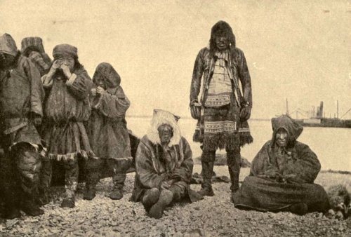 A Chukchi family lined up for a photo near the shore (Novo-Mariinsk,Russia, summer 1906).