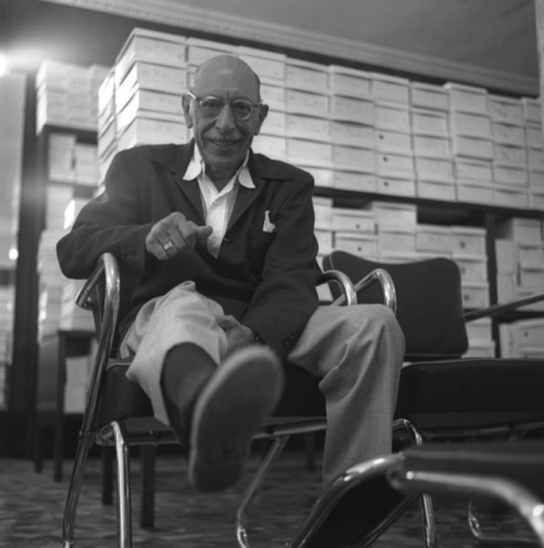 Igor Stravinsky trying on shoes.