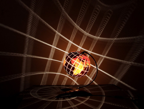 psychoactivelectricity:  This lamp is made of Senegalese gourd.   Meridians and circles of latitude are marked every 20 degrees; the contours of the continents are reconstructed accordingly. The land is marked by a deeper layer of white wood which allows