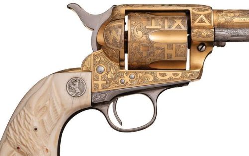 Gold plated and Cattle Brand engraved Colt Single Action Army with carved ivory grips. Manufactured 