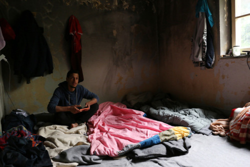 People sleep in an abandoned house at the Greek-Macedonian border.