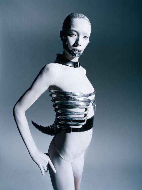 enzeldvst: metal mouthpiece and spine corset from Alexander McQueen SS 1998photographed by Tim Walke