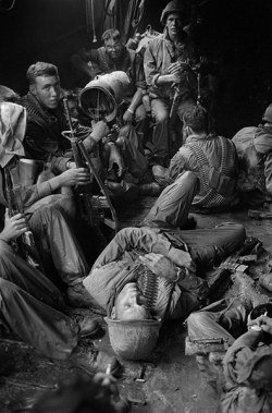 Vietnamwarera:  American Soldiers Rest In A Boat As They Are Transported Through