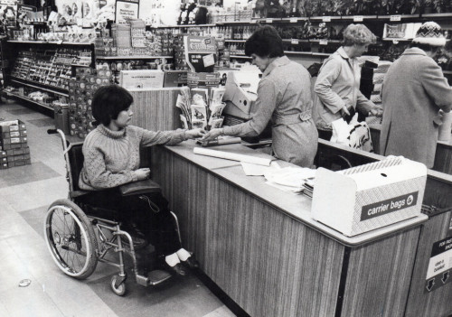 1970s Paraplegic out shopping