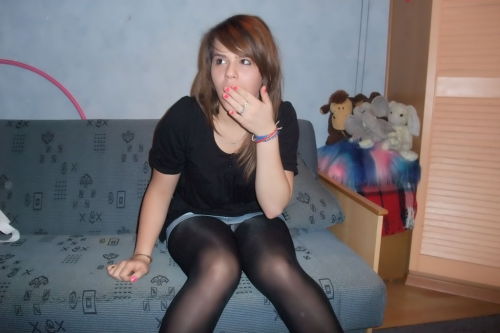 Cute girlfriend in short denim skirt and black pantyhose. Woman in pantyhose