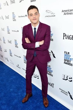 hijadepavlov: [images: first row, Rami Malek at three different events, first wearing a bright purple suit, then a pink flower-patterned suit, and last a sea-green suit.second row, John Boyega at three different events. first wearing a deep blue suit,