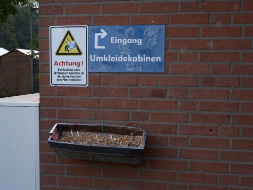 » entrance changing room « early sunday morning at a football field – village in l