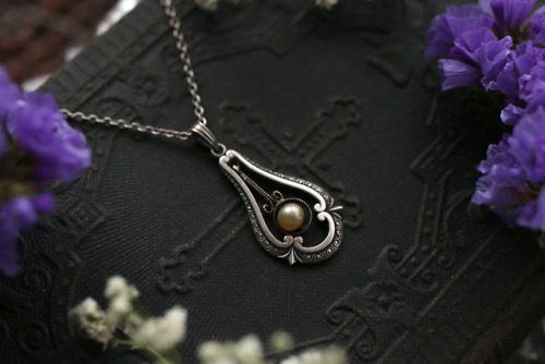 Beautiful old and antique genuine silver necklaces with blue topaz and pearl are available at my Ets