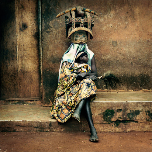 artcomesfirst:“Baba Ichanga” wearing traditional gelede mask and holding a baby, evoking the ancesto