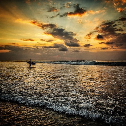 yusupovoleg:  Photo // @jimmy_chin A surfer stands on the razor sharp shallow reef waiting and timin