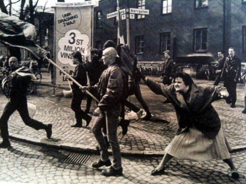 A Swedish woman hitting a neo-Nazi protester with her handbag. The woman was reportedly a concentration camp survivor, 1985.