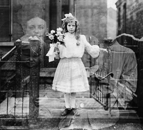 A girl with flowers, a family appearing behind in a double exposure, ca. 1905.