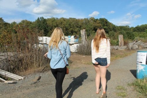 Two hot little sluts showing off their tight little asses in public….
