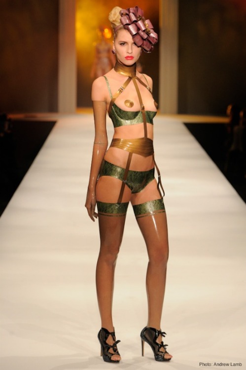 landoflatex:  Look 9: Zoe wears Restricted play-suit and round pasties in antique gold with large rosette hat in pearlsheen rose/antique gold. Also features ½ cup bra and low cut briefs in pearlsheen leaf green lace and opera gloves and stockings