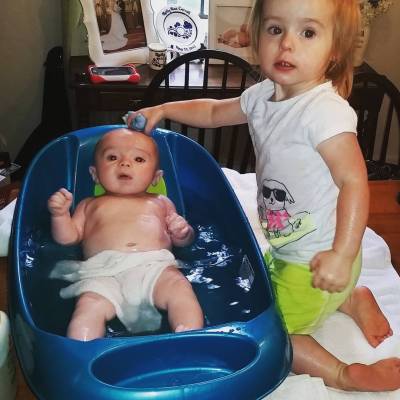 Big sis’ helping with bath time!