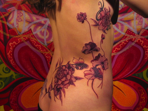 Daemonic Japanese style flowers. Top right is a cover up of a prior tattoo.Tattoo by Daemon Rowanchi