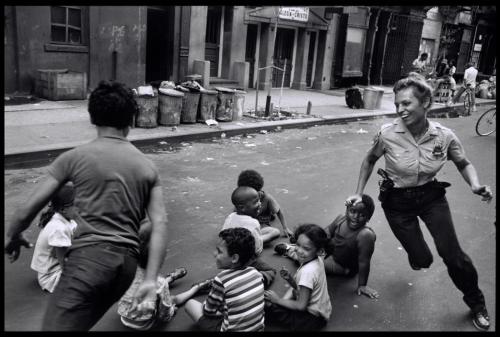 collectivehistory:  A policewoman plays with local kids in Harlem, NYC, 1978 by Leonard Freed.  